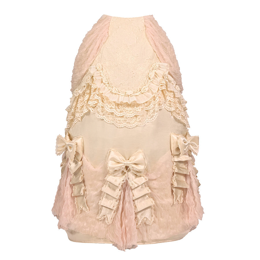 Flat lay of a cream bustle skirt with lace trim and bow accents