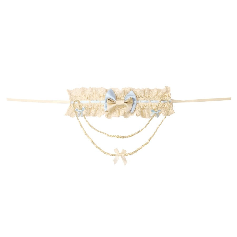 Flat lay of the Butterfly Bow Pearl Necklace item with lace band and chain drape