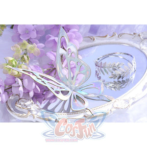 Flat lay of Castorice cosplay costume back chain with silver butterfly wing piece, branch motif, and clear bead