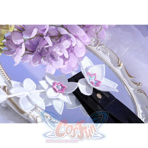 Close-up of Castorice cosplay costume belt flowers with white petals, pink centers, black strap, and silver snaps