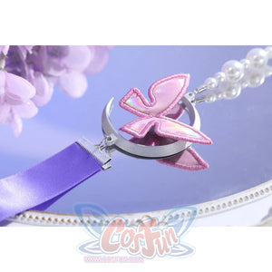 Butterfly charm close-up of Castorice cosplay costume with pink wing ornament, silver crescent, and pearl chain