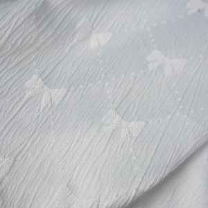 Honkai: Star Rail Castorice Gossamer Flutter cosplay costume white fabric texture beside embroidered bow patterns.