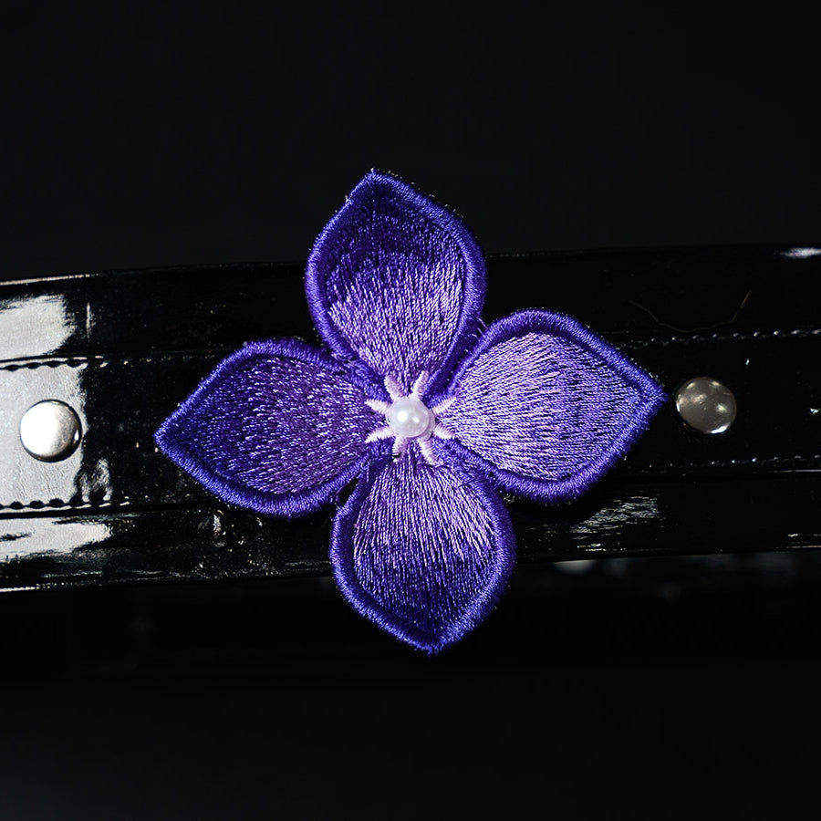 Honkai: Star Rail Castorice Gossamer Flutter cosplay costume presents a dark purple embroidered flower upon a glossy strap.