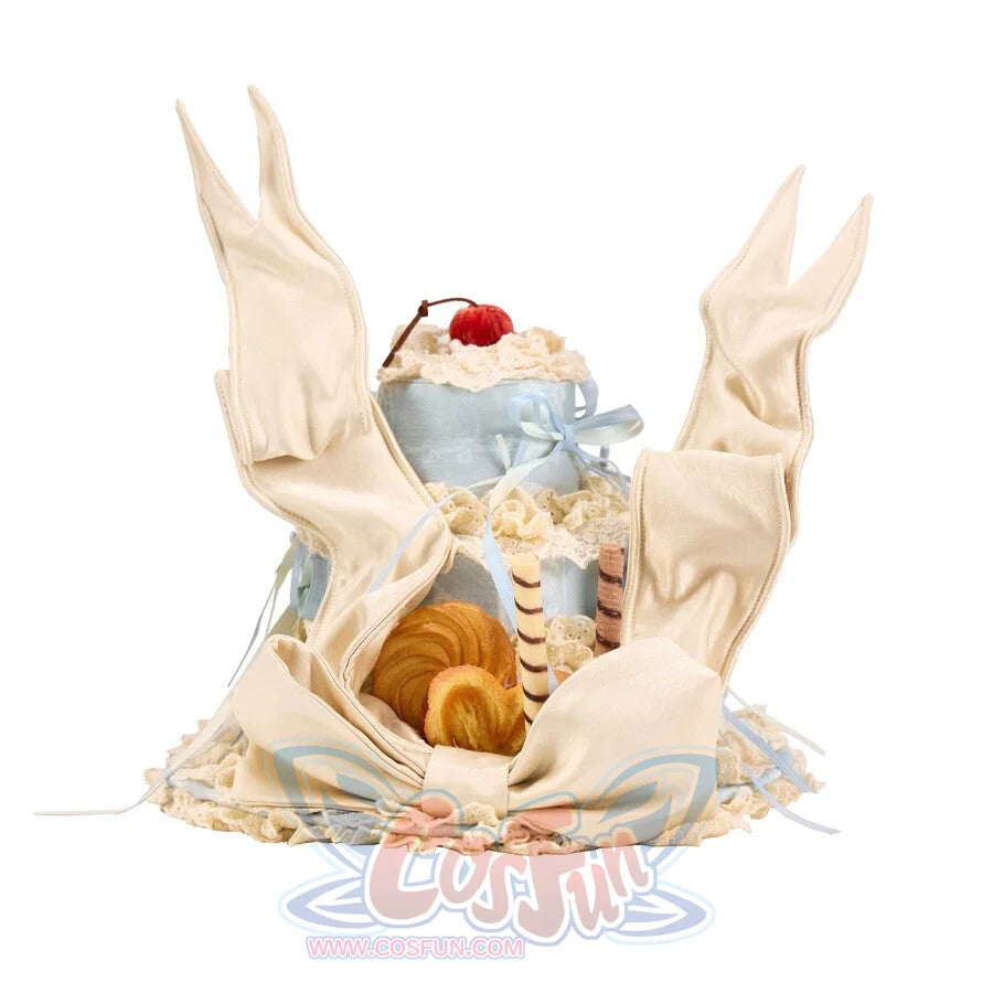 Flat lay of the Cookie Cake Ribbon Hat item with satin wing details, lace trim, and dessert accents