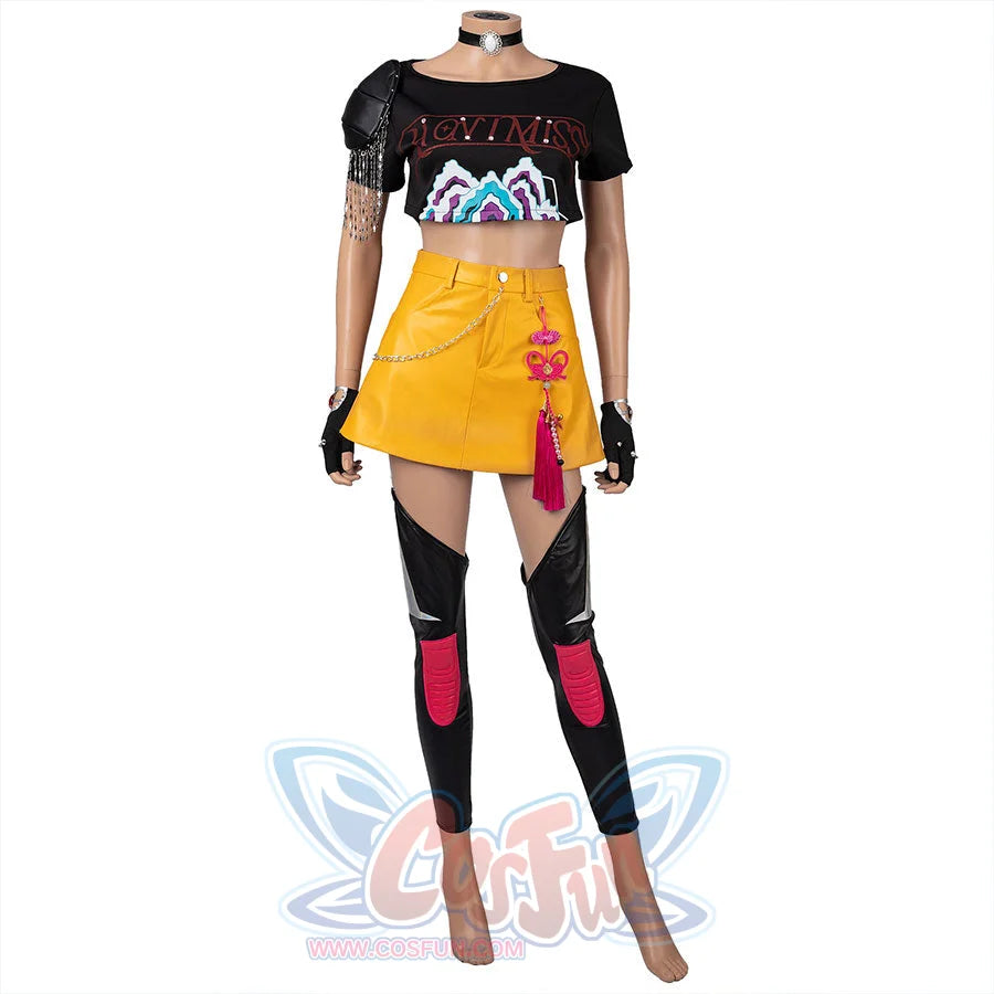 Idol Mira cosplayer wearing a black crop top with colorful graphics, yellow skirt, and black knee-high boots on a blue background