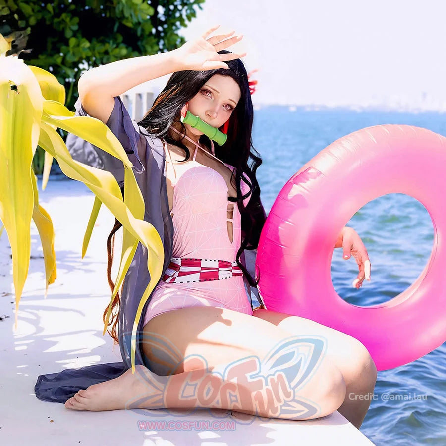 Nezuko cosplay swimsuit layers a pink one-piece beneath sheer black sleeves and red waist trim.