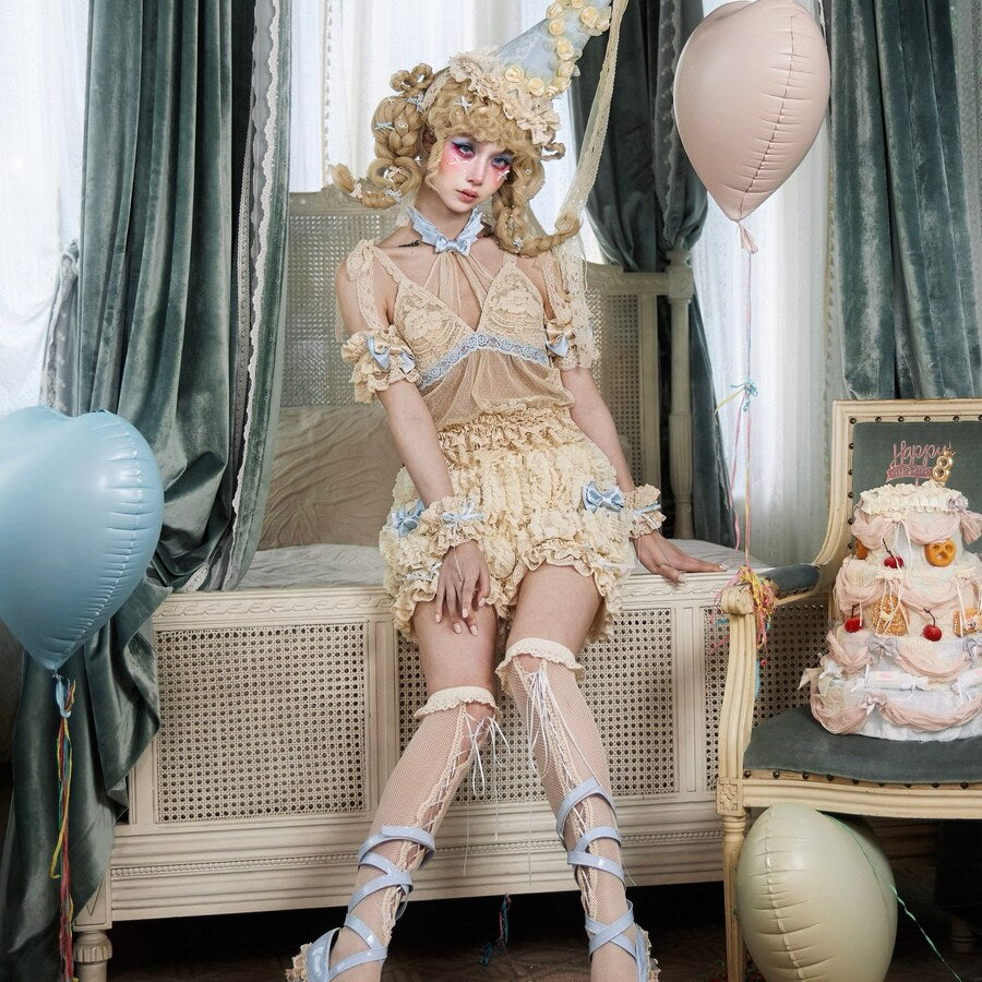 Seated styling showing the Halter camisole item with cream ruffled coordinate pieces