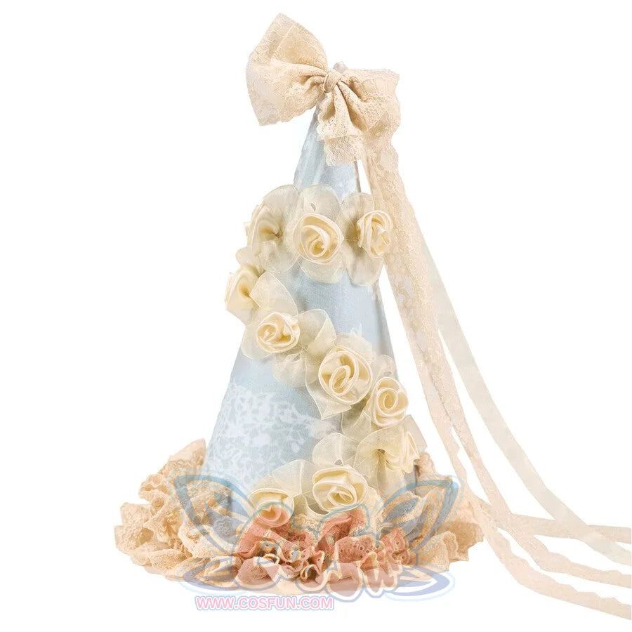 Flat lay of the Cream Pointed Hat item with pale blue panels, rose trim, lace base, and bow streamers