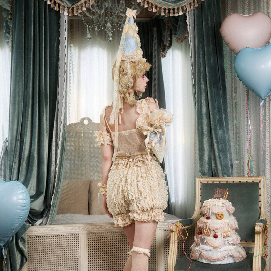 Back styling view of cream pumpkin bloomers with layered ruffles and elastic leg openings