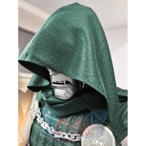 Doctor Doom cosplay costume layers a textured green fabric hood over a metallic face mask and intricate shoulder armor.