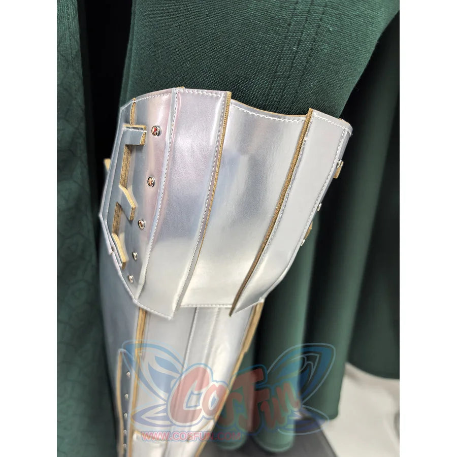 Doctor Doom cosplay costume silver-tone metallic leg guard armor rests against the textured green fabric of the cape garment.