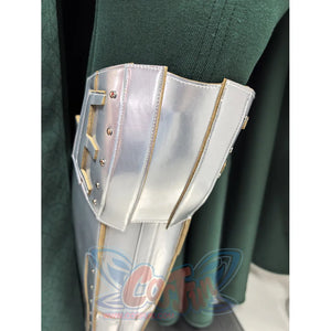 Doctor Doom cosplay costume silver-tone metallic leg guard armor rests against the textured green fabric of the cape garment.