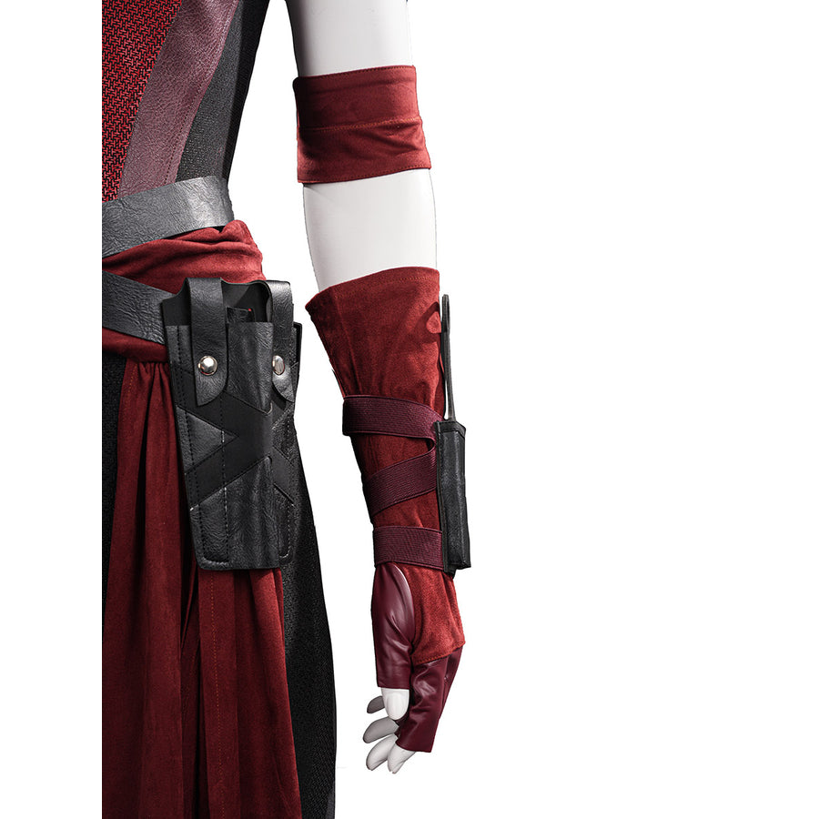 Elektra cosplay costume traces red suede-like fabric textures across the arm sheath strap and coordinated fingerless gloves.
