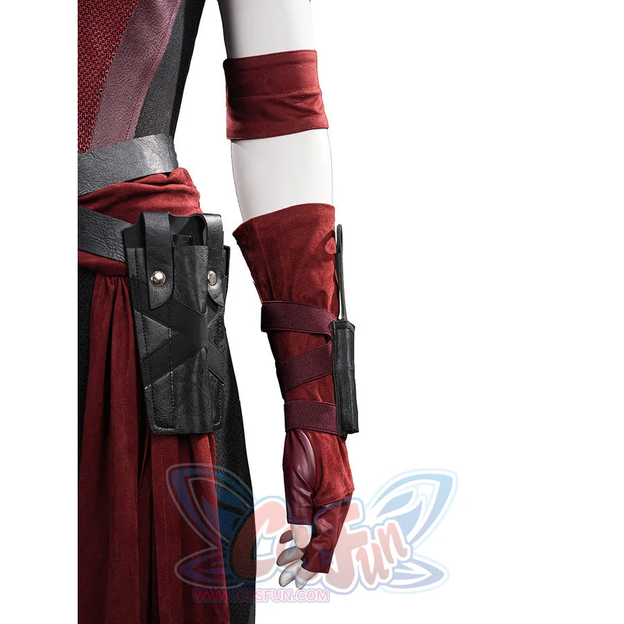 Elektra cosplay costume traces red suede-like fabric textures across the arm sheath strap and coordinated fingerless gloves.