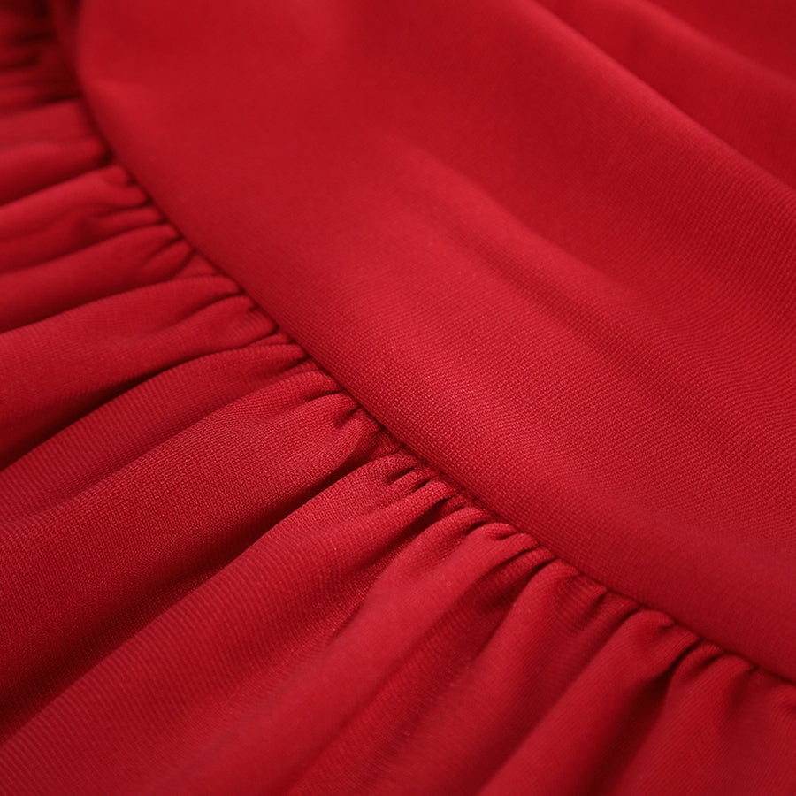 Elektra Natchios cosplay costume red stretch fabric gathers along a seam to create soft vertical folds in the material.