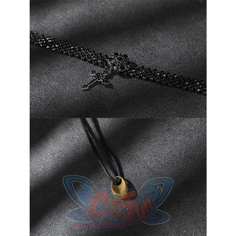 Close-up of a black beaded choker-style accessory and a black cord with a small gold-toned end piece.