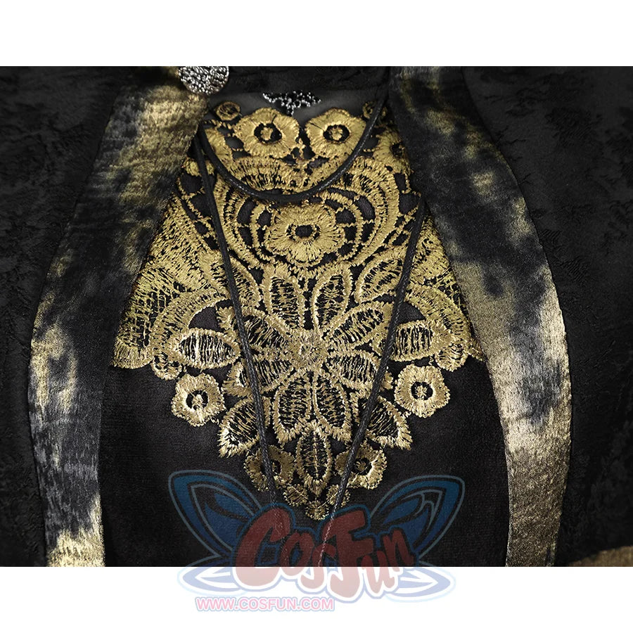 Close-up of the Fire Keeper costume gold chest embroidery beneath the cape, framed by dark metallic trimmed panels.