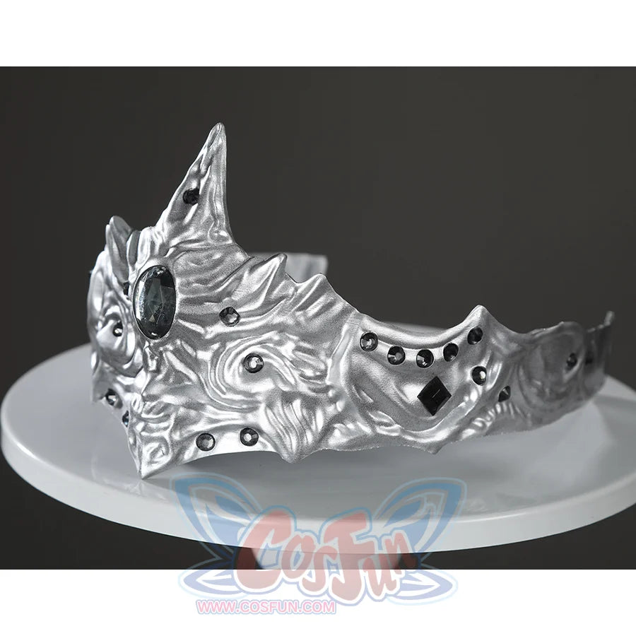 Angled view of the Fire Keeper silver mask accessory displayed alone, showing sculpted contours and dark gems.