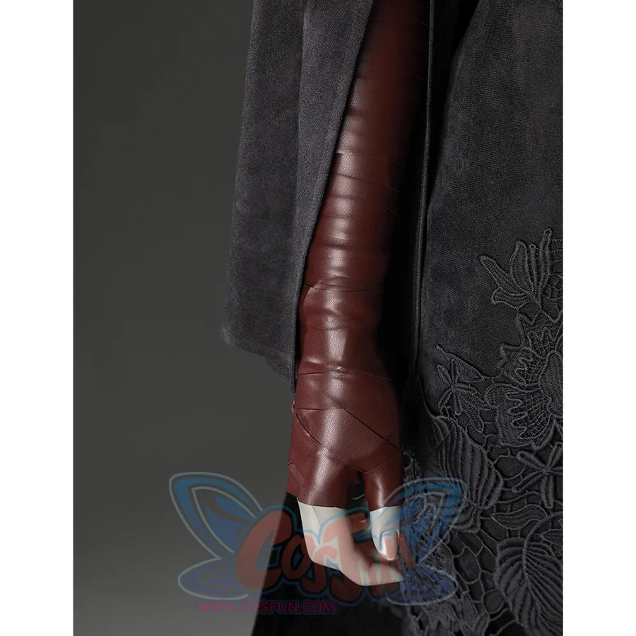 Close-up of the Fire Keeper costume sleeve and brown glove, with black embroidered skirt panel visible at the side.