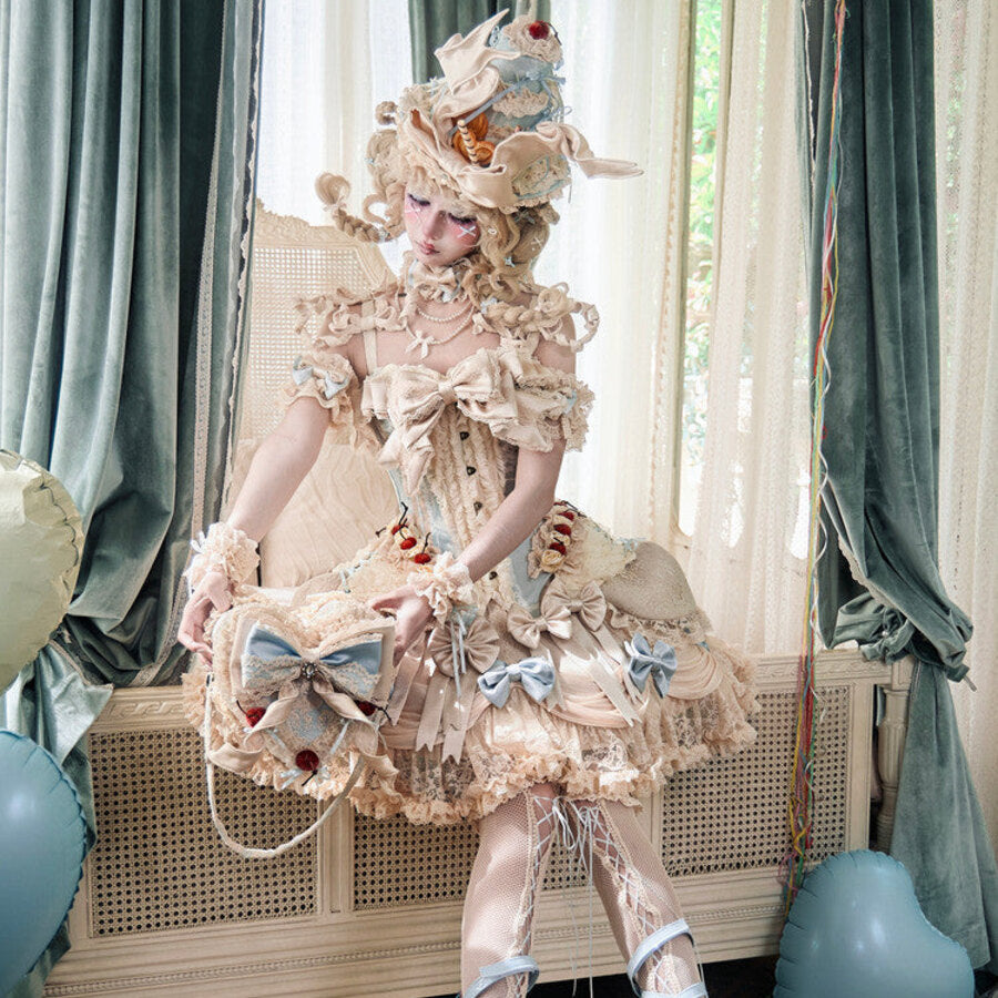 Full Lolita styling with cream lace bodice, layered skirt, and blue ribbon accents
