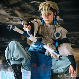 Gachiakuta Zanka Nijiku cosplay costume frames the chest pendant and tassels around a forward staff pose