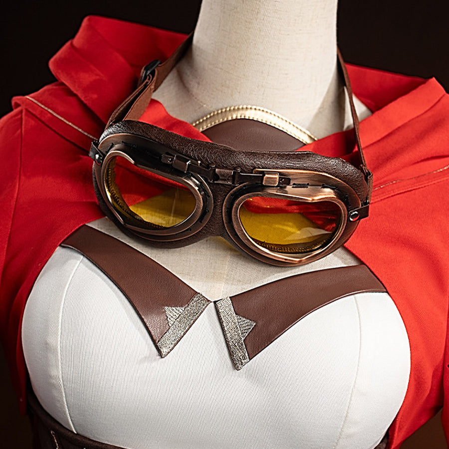 Close-up of Amber cosplay costume chest with brown goggles, red cape, straps, and white bodice on mannequin