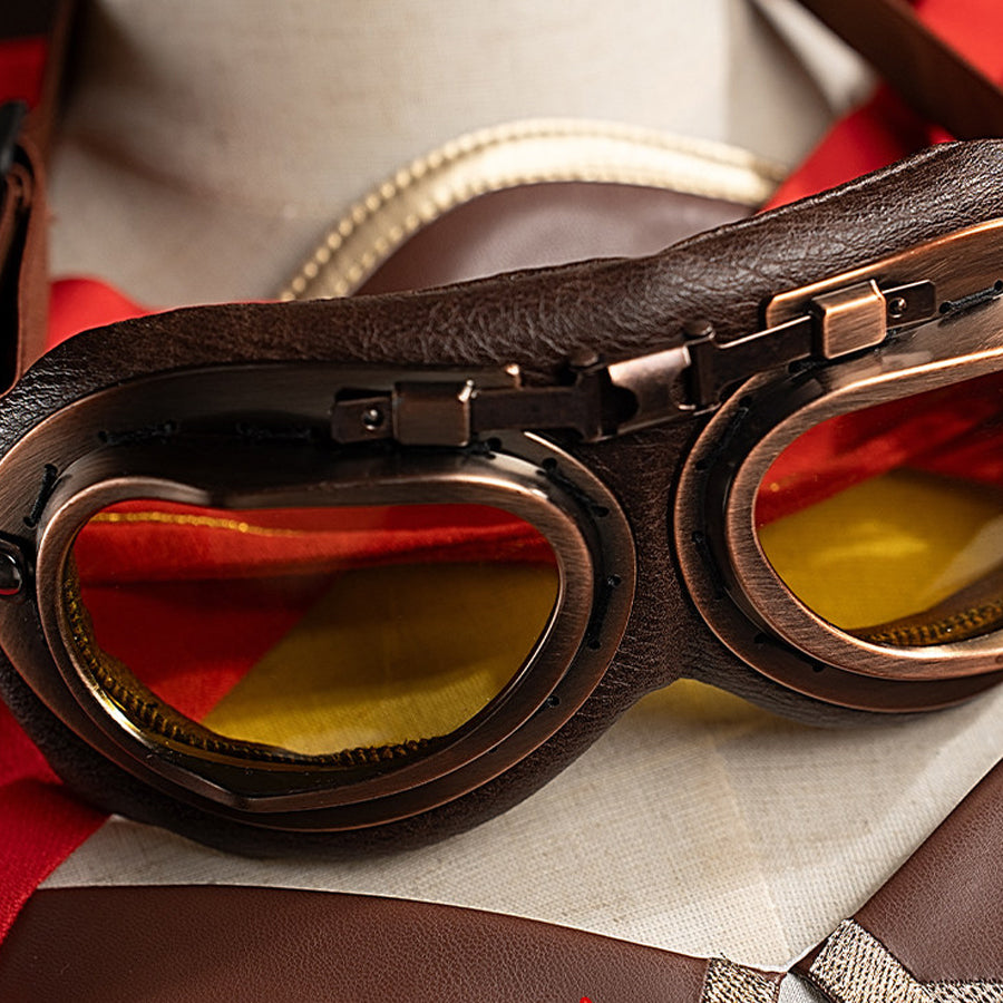Close-up of Amber cosplay goggles worn on a mannequin, showing the brown frame, yellow lenses, and strap detail