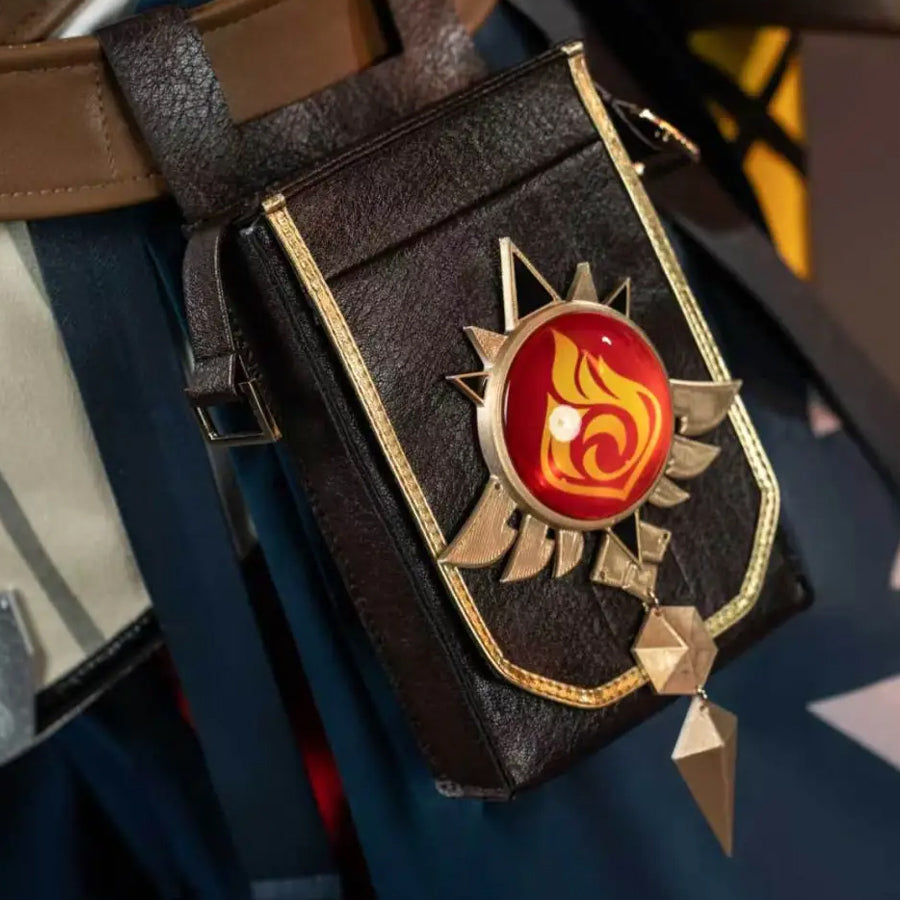 Genshin Impact Bennett cosplay pouch close-up centers a red vision emblem against black faux leather and gold-tone trim