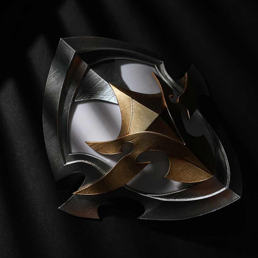 Genshin Impact Lohen cosplay costume knee guard centers a structured metallic piece layered in gold-tone and silver-tone.