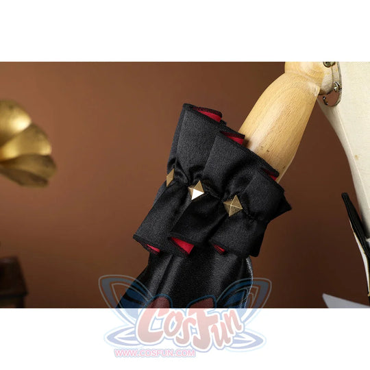 Genshin Impact Sandrone cosplay costume has a black ruffled cuff with red lining and gold diamond embellishments.