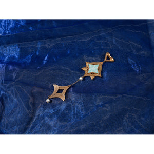 Genshin Impact Snezhnaya Odette cosplay dangling accessory flat lay sets teal trim beside tiny bead drops.