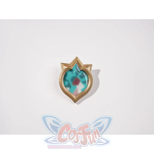 Genshin Impact Vesna cosplay costume Vision ornament centers a turquoise faceted center inside a gold-tone frame.