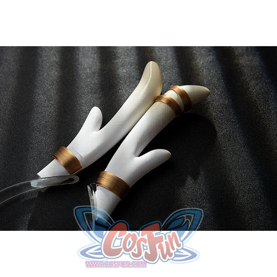 Genshin Impact Yanfei cosplay finger covers detail rests white claw-like pieces beside gold bands.