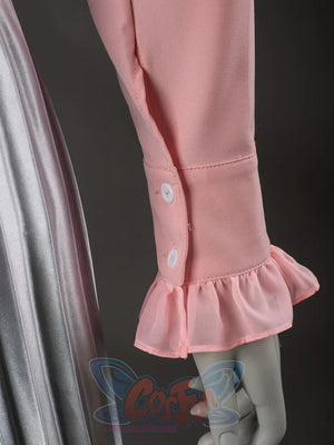 Glinda cosplay blouse cuff close-up with white buttons above a soft pink ruffled sleeve edge