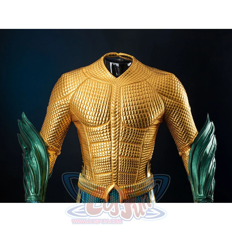 Gold-tone armored cosplay chest close-up captures raised grid texture and teal wrist guards at the sides.