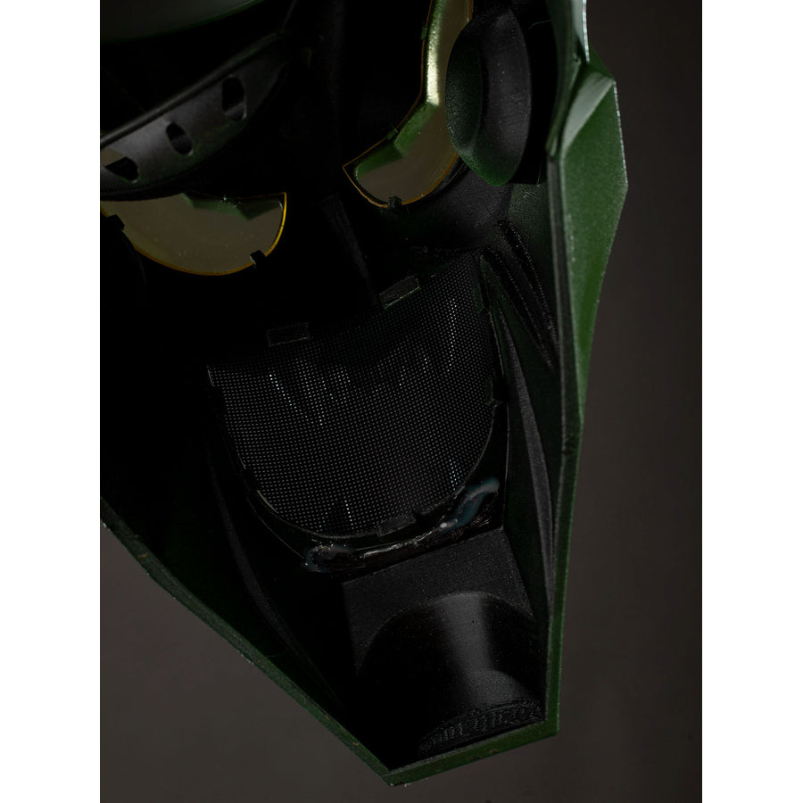 Green Goblin Norman Osborn cosplay helmet chin close-up layers black mesh behind the green face plate.