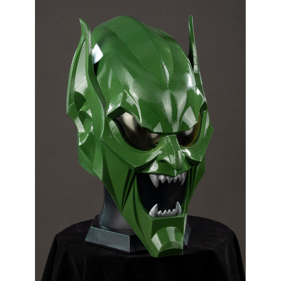 Green Goblin Norman Osborn cosplay helmet angled front view centers dark eye lenses and pointed teeth.
