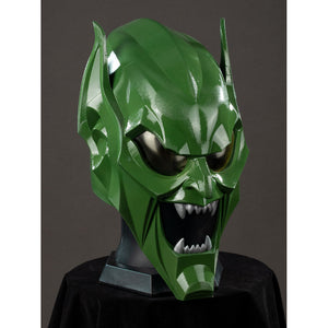 Green Goblin Norman Osborn cosplay helmet angled front view centers dark eye lenses and pointed teeth.
