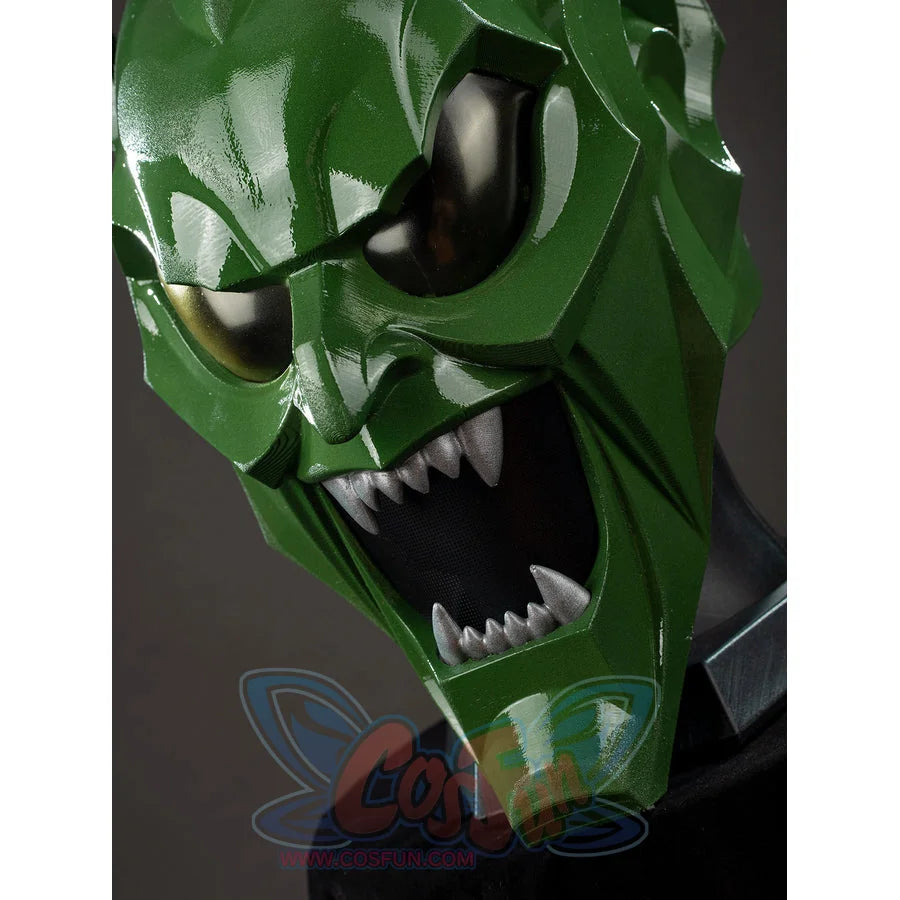 Green Goblin Norman Osborn cosplay helmet close-up frames dark lenses above jagged white teeth.