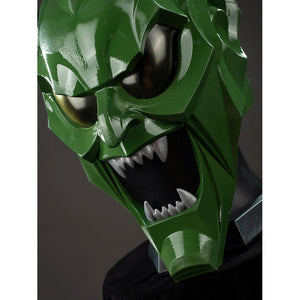 Green Goblin Norman Osborn cosplay helmet close-up frames dark lenses above jagged white teeth.