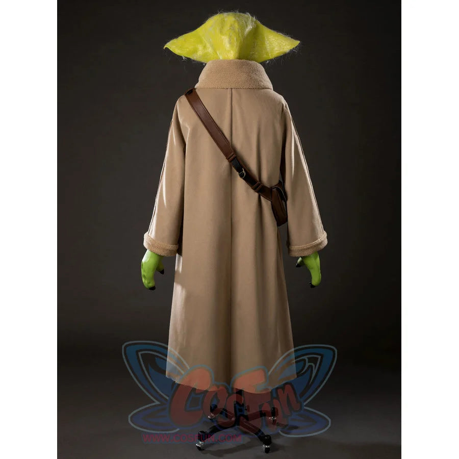 Grogu cosplay costume layers a woolen robe with sherpa trim over a brown crossbody bag and green latex accessories.