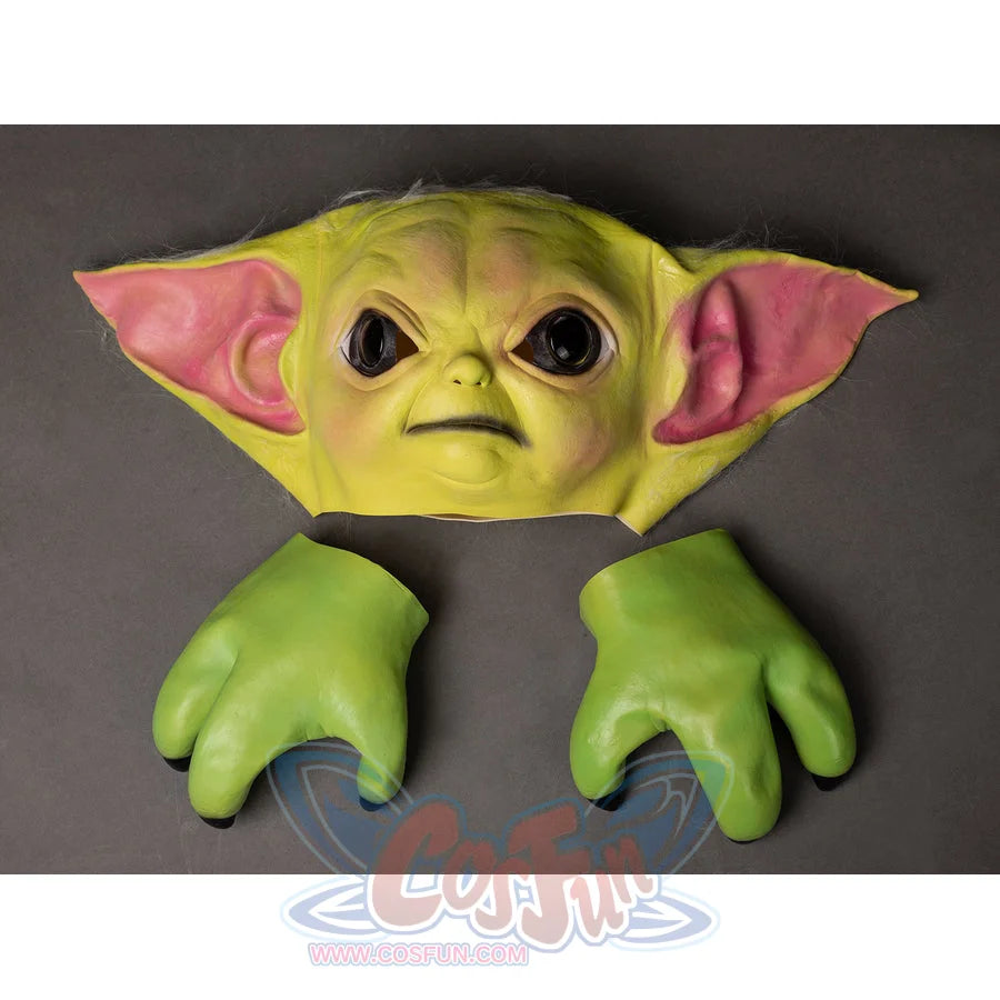 Grogu cosplay headpiece and claws curve across the frame to frames detailed skin texture and bright green skin coloring.