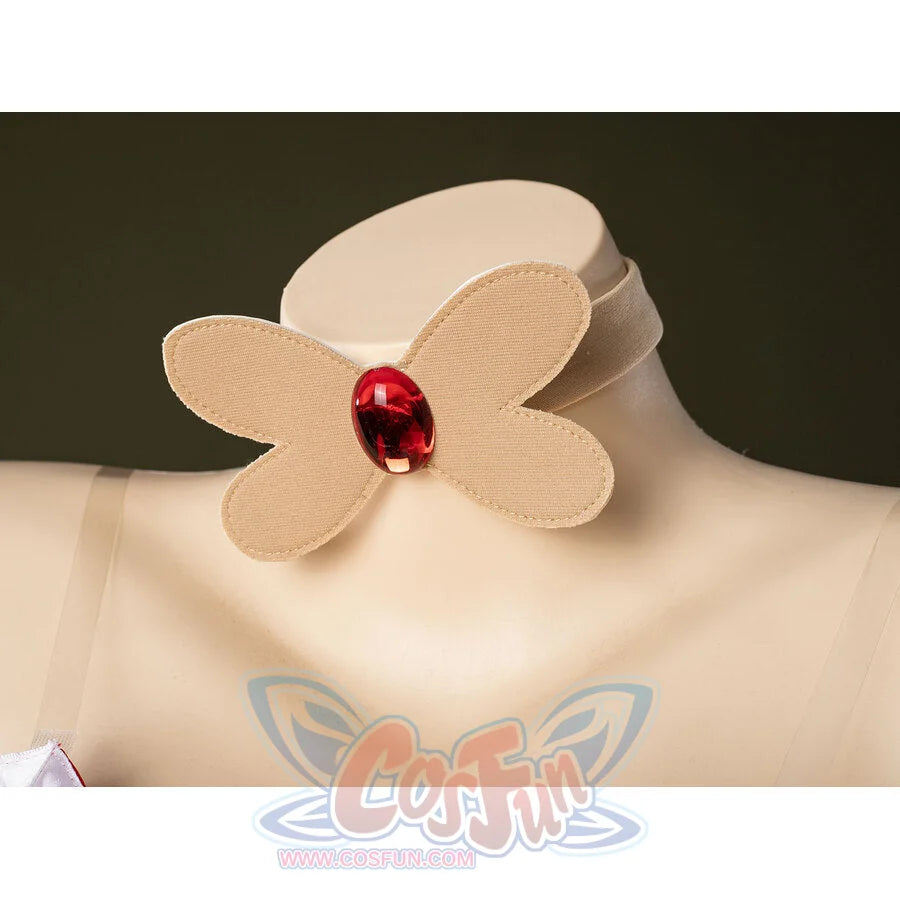 Close-up of Charlie Morningstar choker accessory with beige butterfly shape, red oval gem and soft fabric band