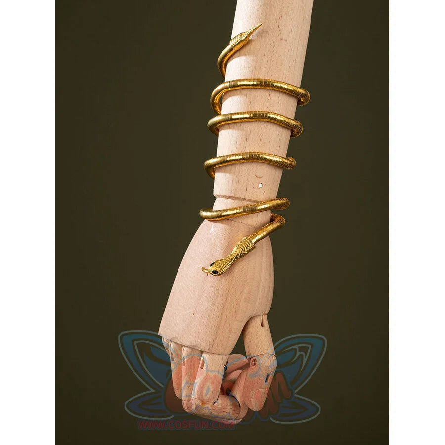 Worn view of Charlie Morningstar snake arm cuff with gold coiled shape, black eyes and wrapped bracelet form