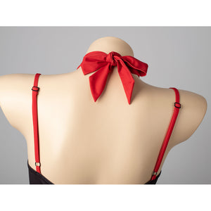Hazbin Hotel Husk cosplay swimsuit bow close-up centers red neck ties between slim shoulder straps.
