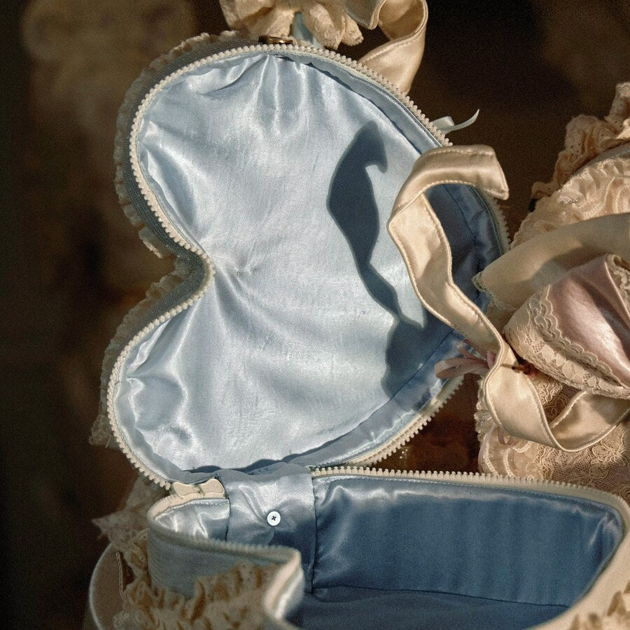 Open heart handbag showing blue satin lining and double-head zipper opening