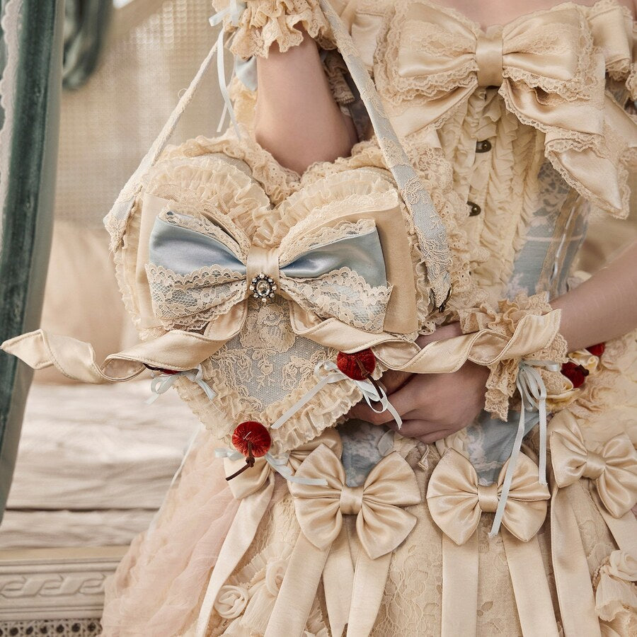 Heart handbag held with a cream Rococo Lolita outfit showing front bow and lace details
