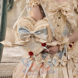 Heart cake handbag held with a cream Rococo outfit showing front bow and lace details
