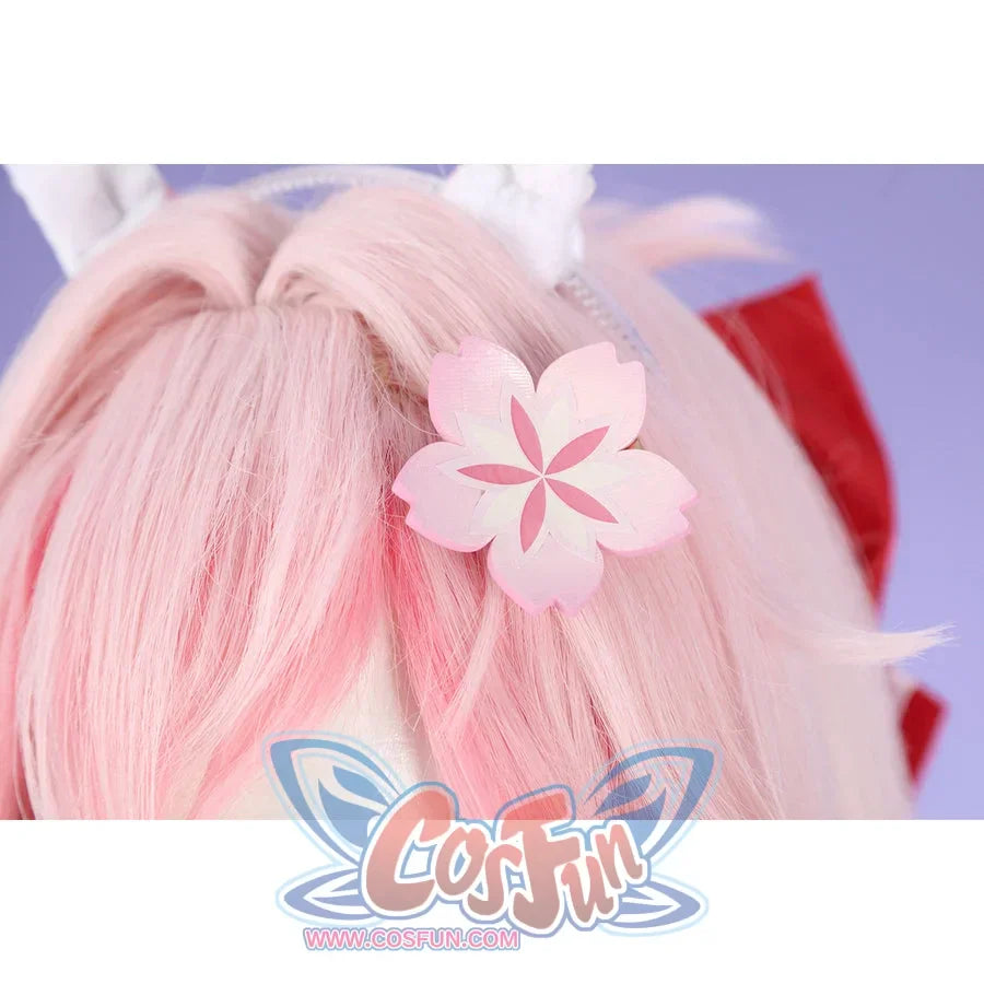 Honkai: Star Rail Evanescia cosplay hair accessory close-up shows pink flower petals beside a red ribbon