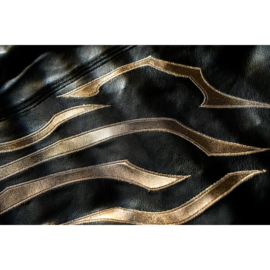 Honkai Star Rail Khaslana cosplay cape detail traces layered gold lines across black fabric